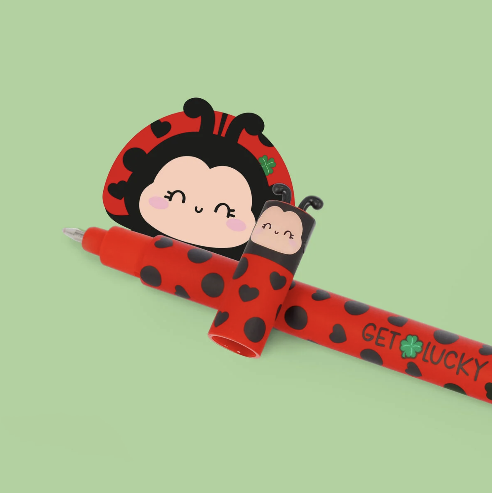 Red ladybug charm with two smiling faces and black spots on a green background, labeled “GET LUCKY”