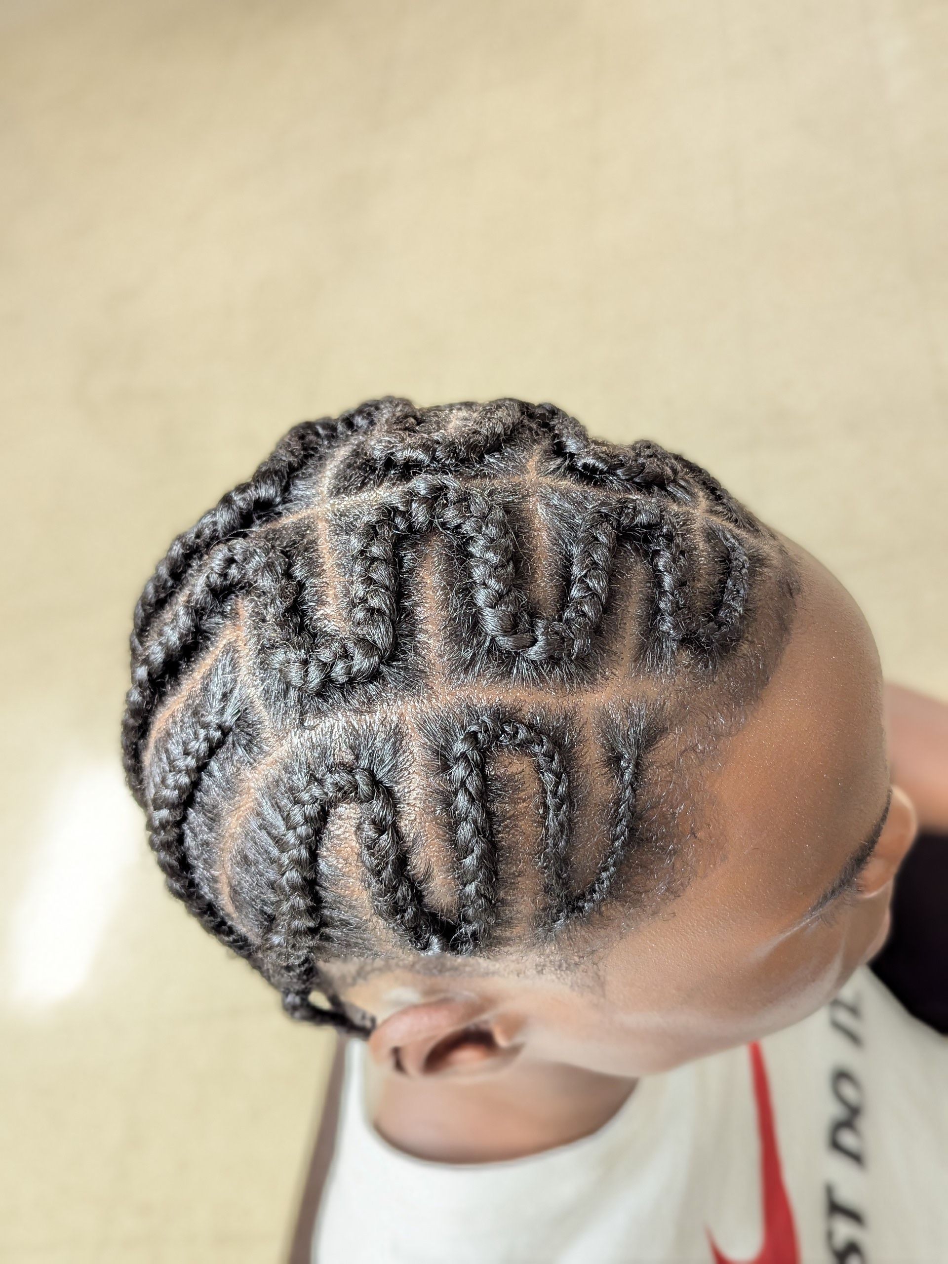 Top-down view of braided cornrows with a zigzag pattern on a person's head