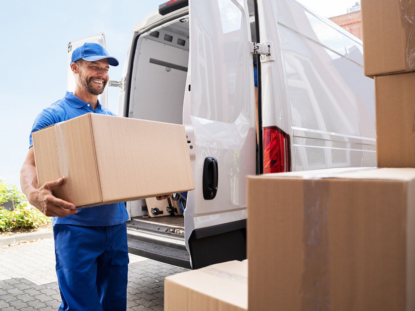 truck mover unloading van carrying boxes