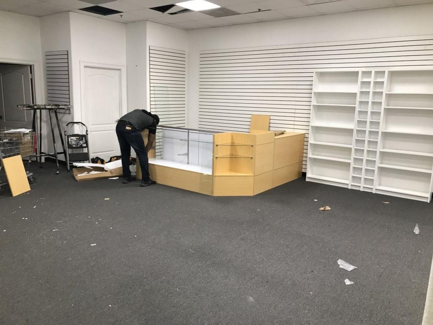 man assembling a corner cabinet