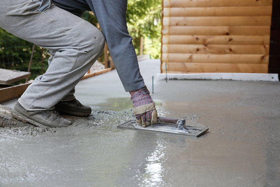 someone spreading the fresh cement