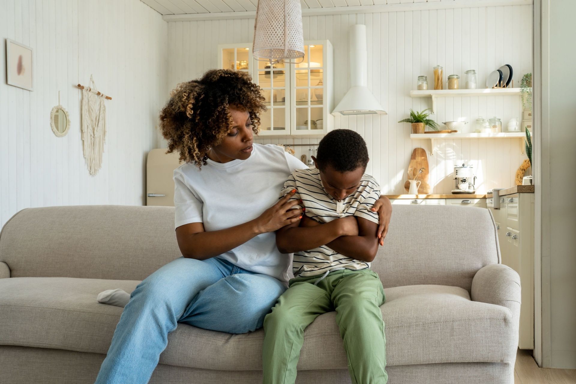A man and a little girl are sitting on a couch.