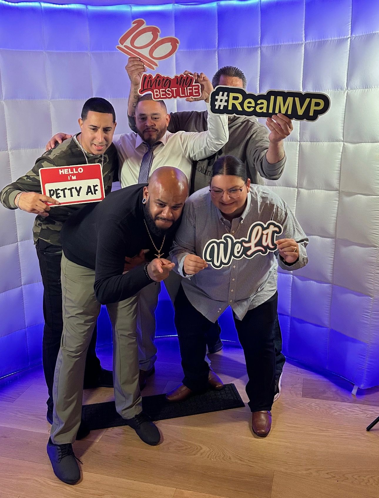 A group of men are posing for a picture in a photo booth.