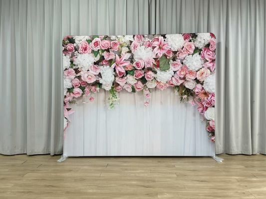 A white wooden wall with pink and white flowers on it.