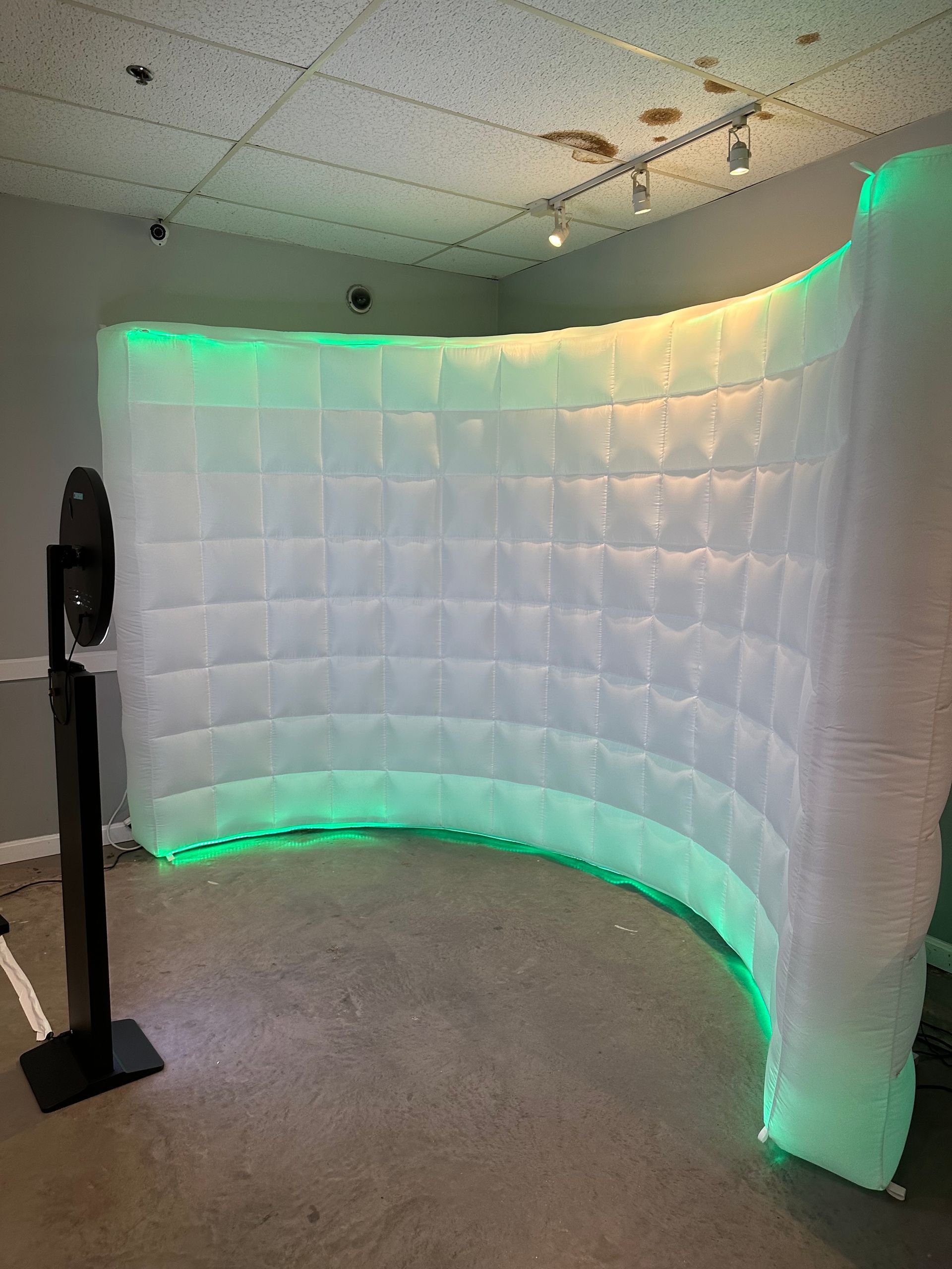 A room with a curved wall and green lights on it.