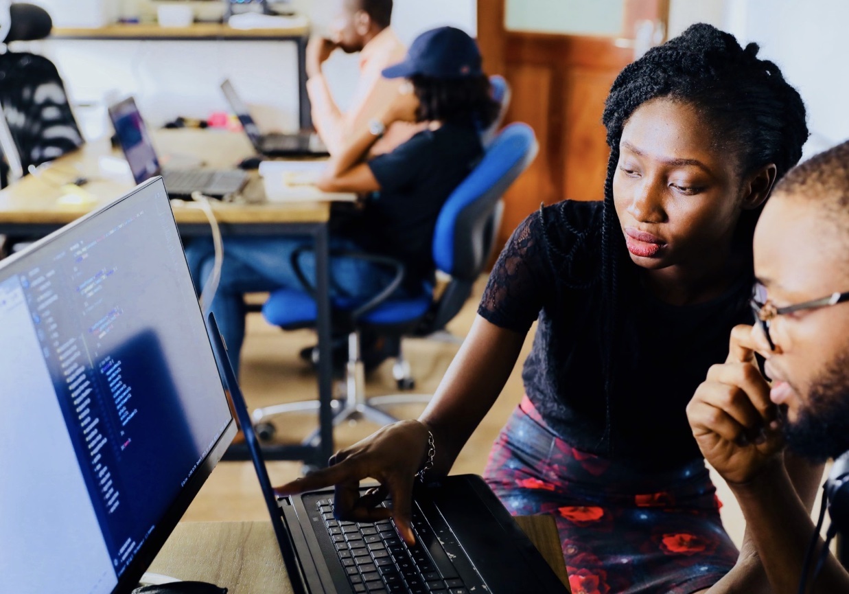 woman pointing at computer
