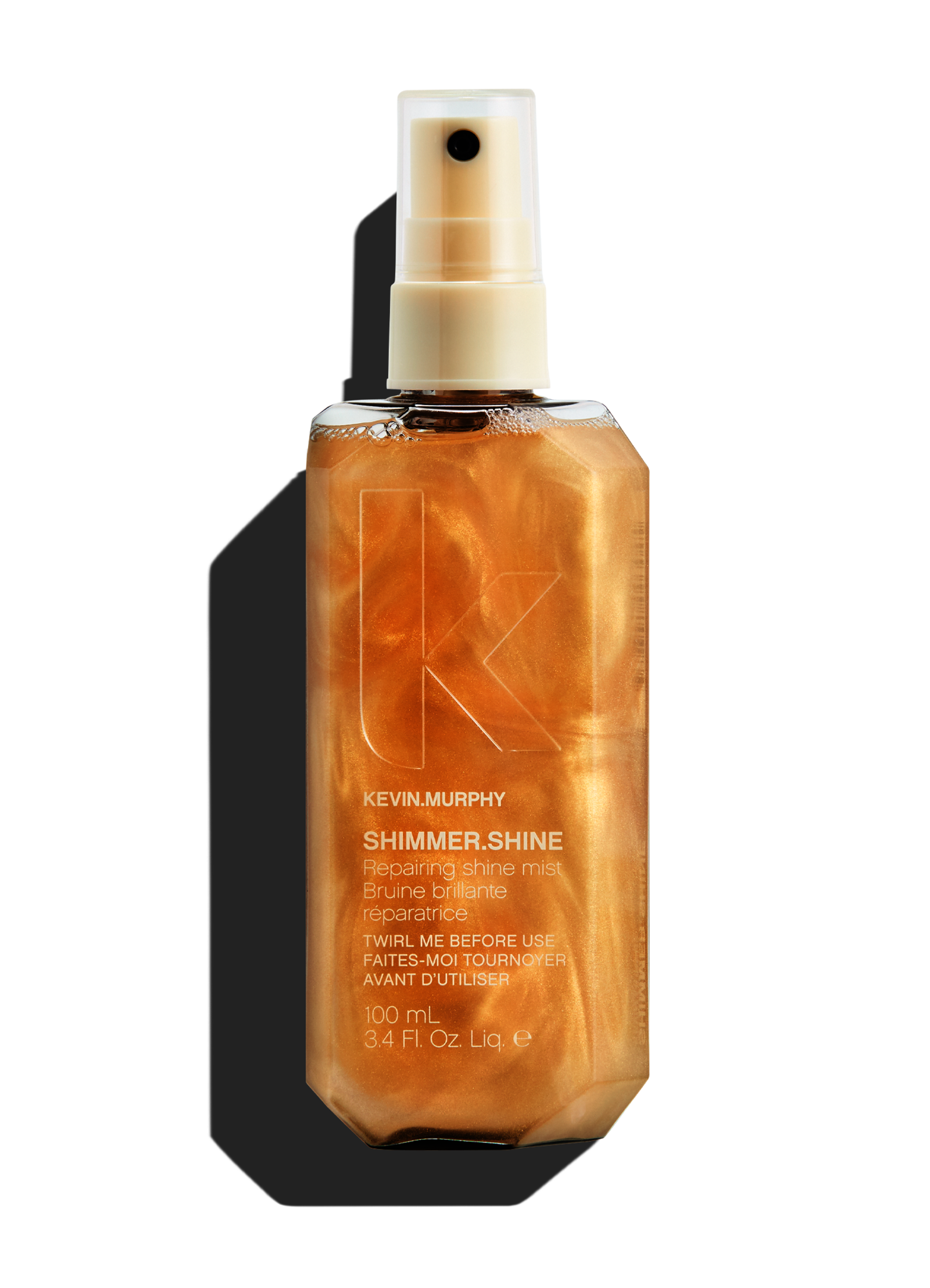 A gold, shimmering hair shine spray bottle with a pump top.