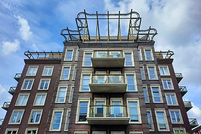 A large brick building with a lot of windows and balconies