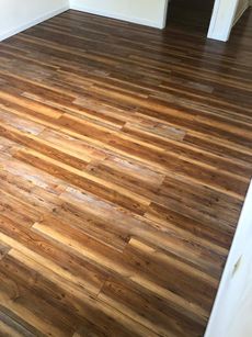 A room with a wooden floor and a white wall.