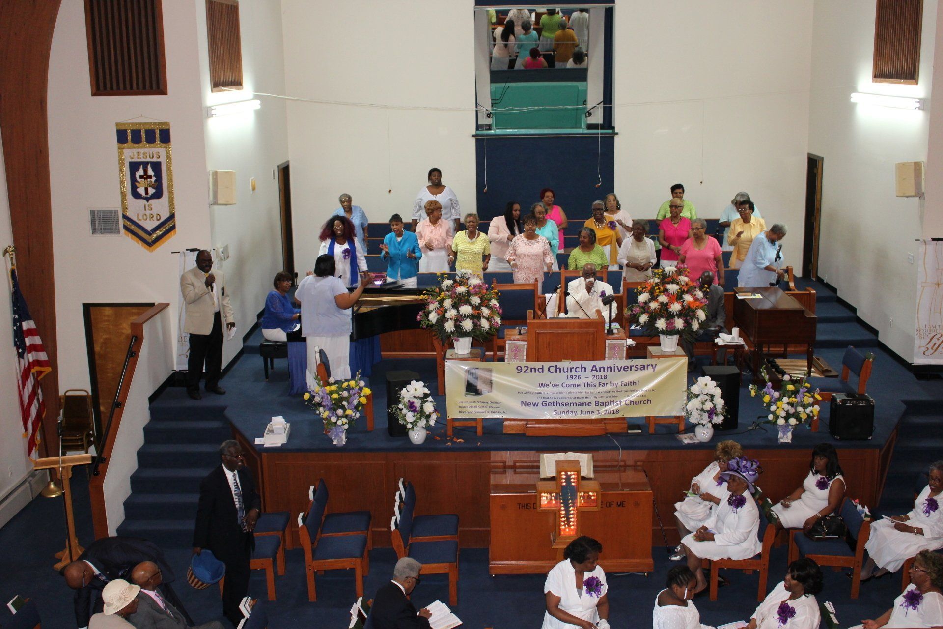 Church sanctuary with a decorated stage and people gathered for a community event