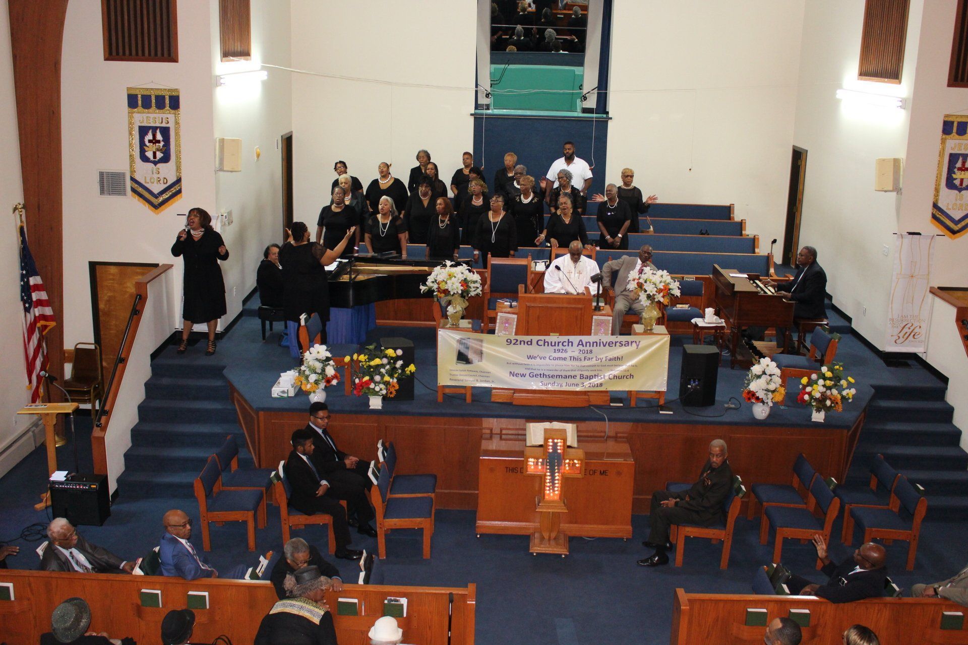 Church choir and congregation gathered in a sanctuary around an altar during a service
