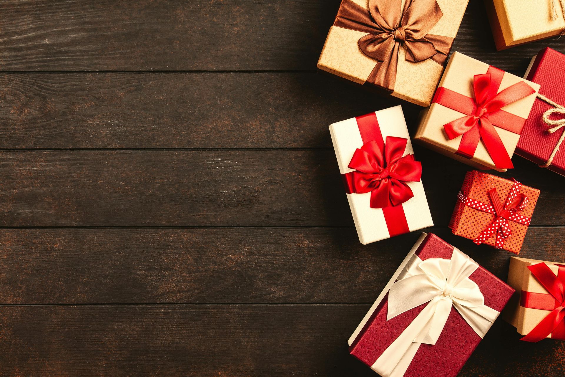 A bunch of gifts are sitting on a wooden table.