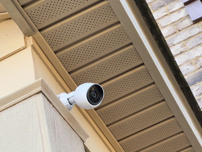 PoE dome camera being mounted on an exterior soffit