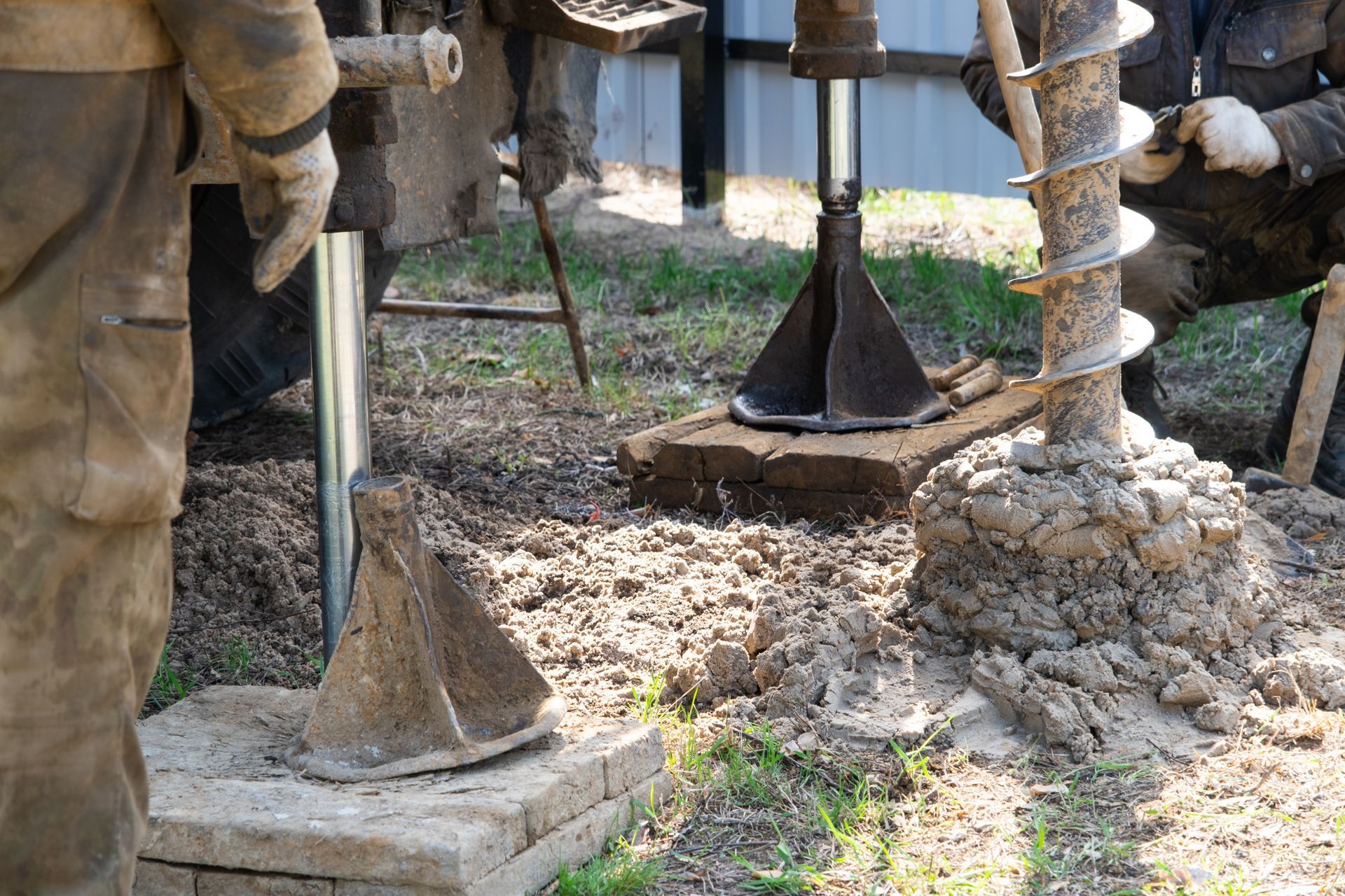 The water well drilling crew operates a heavy auger rig for deep groundwater access.