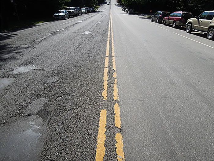 road in poor condition in one lane and in good condition in the other lane because of preservation