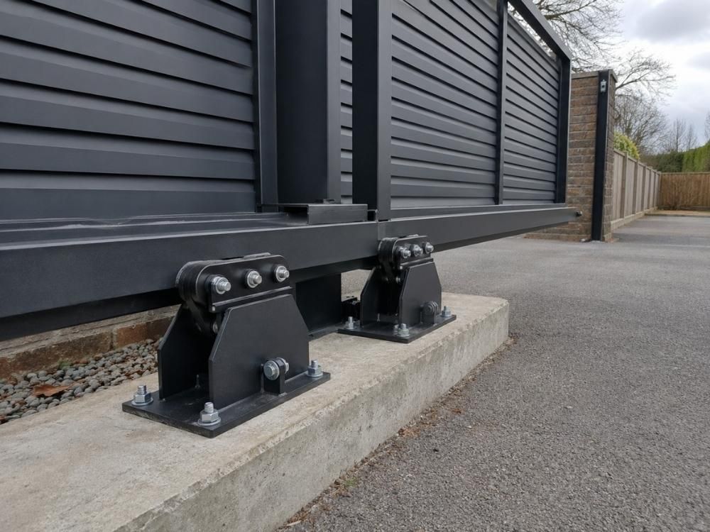 Roller carriages and counterbalance section of a cantilever gate mounted on a concrete foundation