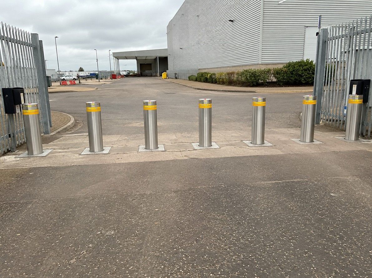 Multiple electric bollards controlling vehicle access at a commercial property entrance
