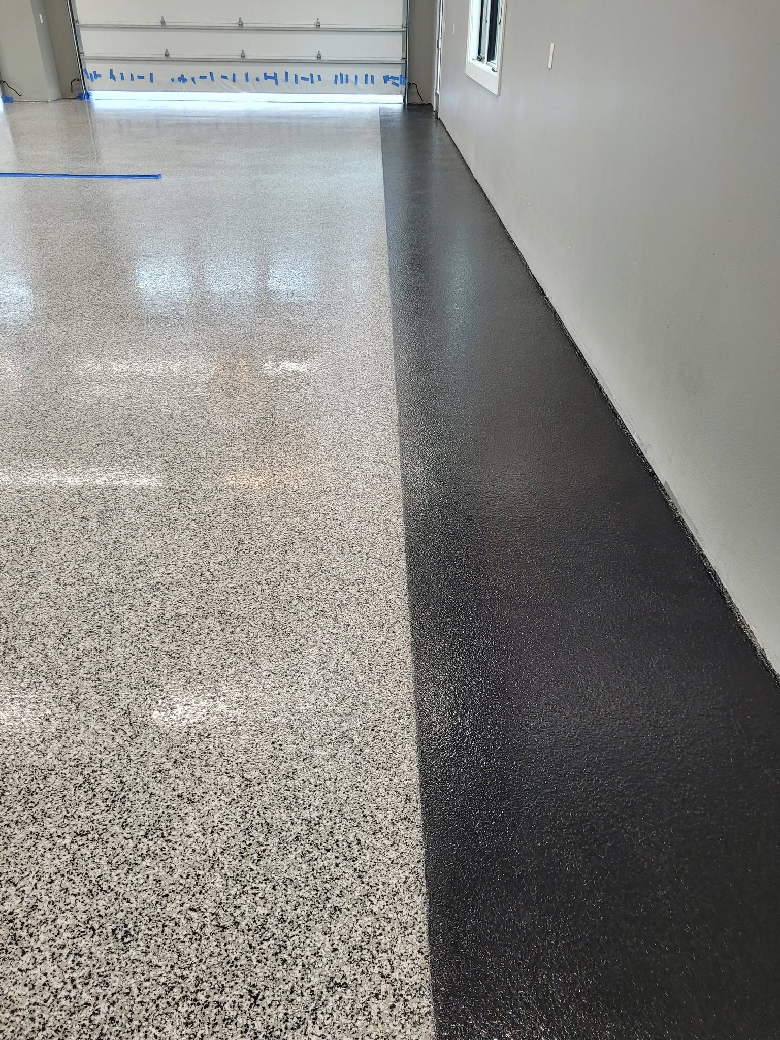 A garage with a staircase and a gray floor