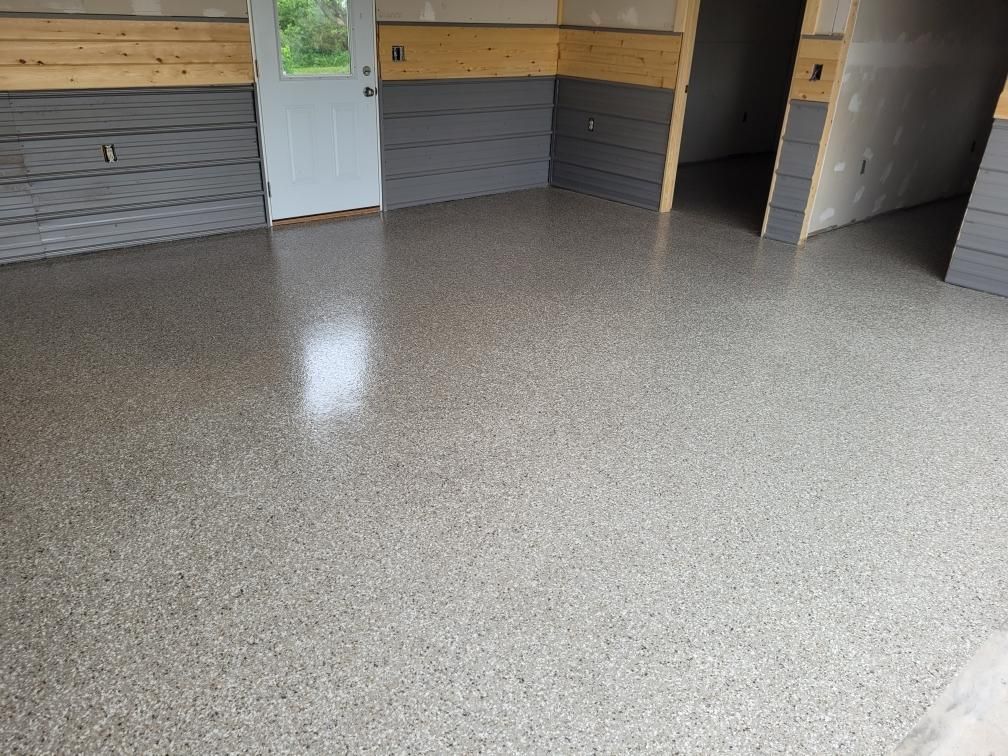 A garage with a concrete floor and a garage door.