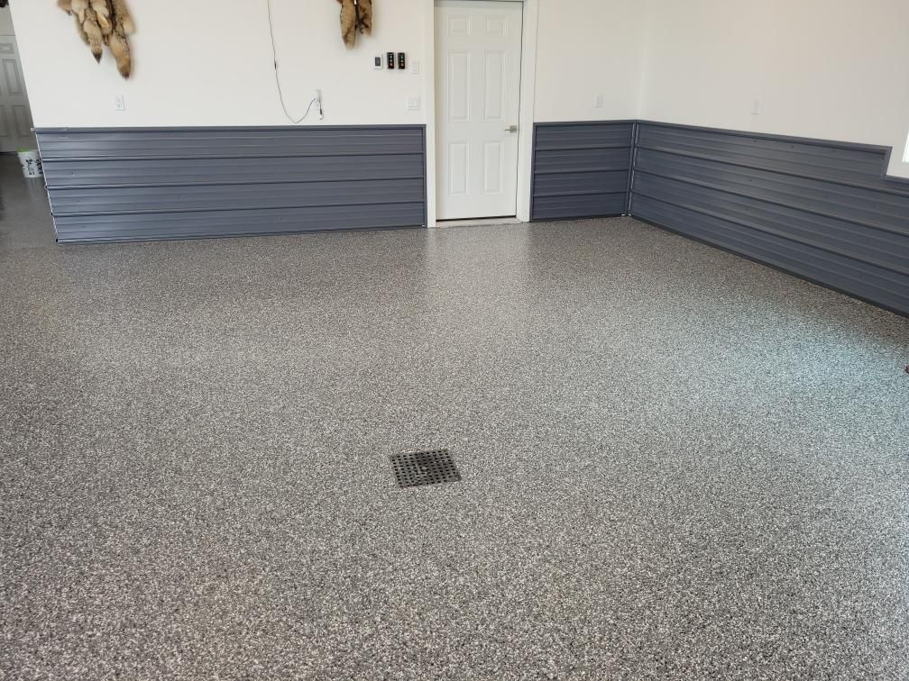 A garage with a gray floor and white walls.