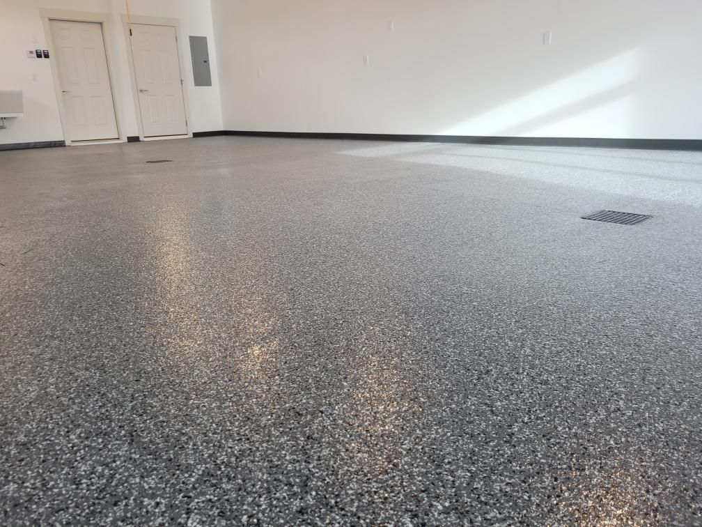 A garage with a gray floor and white walls.