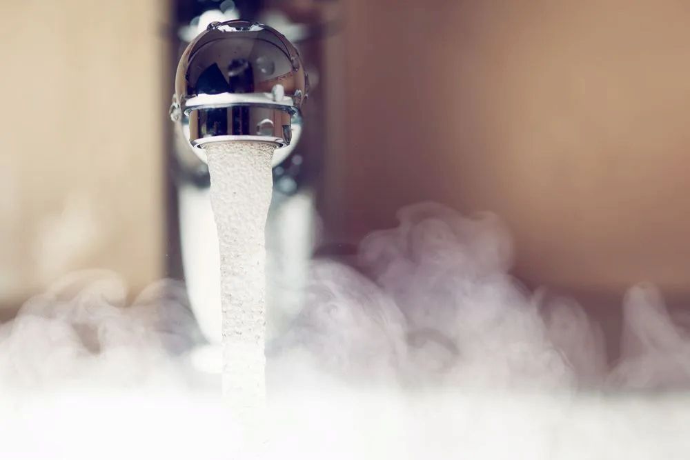 A Chrome Faucet Running Hot Water — The Plumbing & Drainage Co. in Bowral, NSW