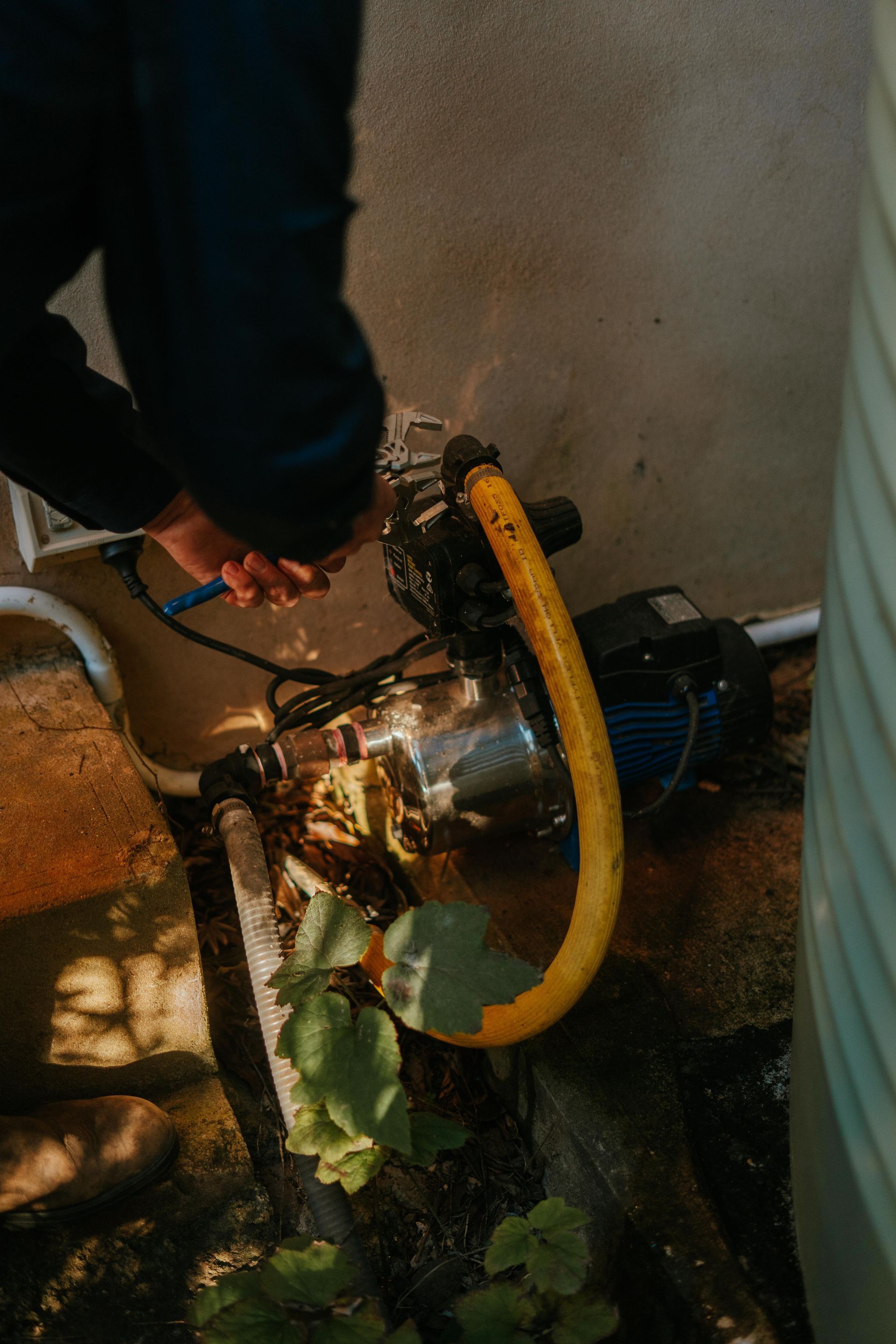 Hands washing under running water at a white sink with a chrome faucet in a restroom — The Plumbing & Drainage Co. in Shellharbour, NSW