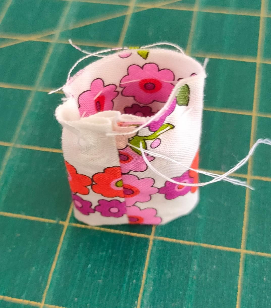 A Piece of Fabric with Pink Flowers on It Is Sitting on A Green Cutting Board — Stitch 2340 In Tamworth, NSW