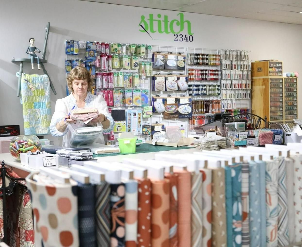 A Woman Is Standing Behind a Counter in A Sewing Shop — Stitch 2340 In Tamworth, NSW