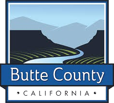 The logo for butte county california shows a river running through a valley with mountains in the background.