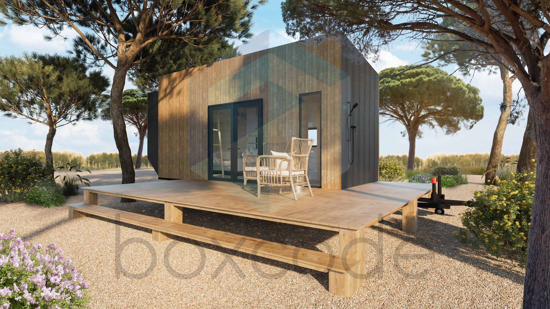 Wooden cabin with deck in a natural setting. Dining set on deck, surrounded by trees and bushes.
