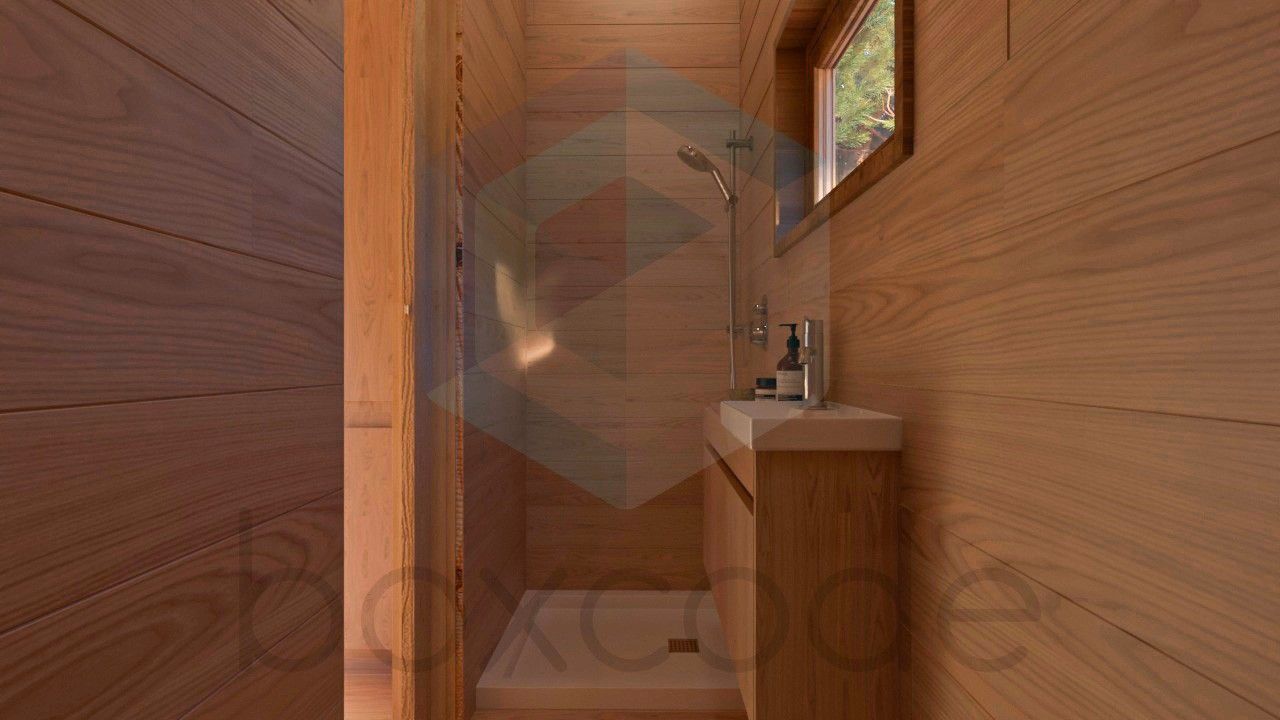 Small, wooden bathroom with sink, shower, and window.