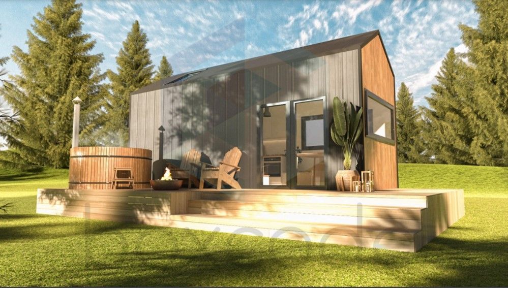 Cabin with hot tub and Adirondack chairs on a wooden deck in a forest setting.