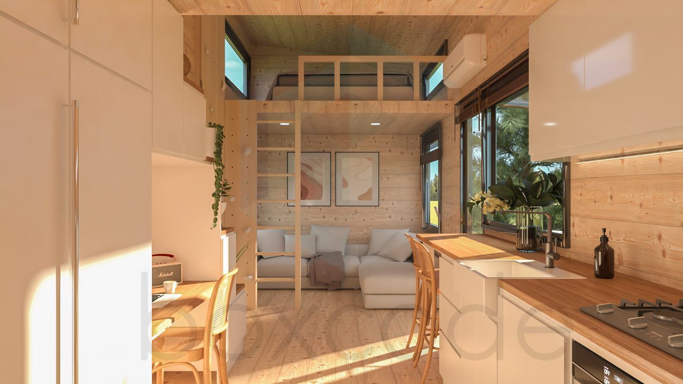 Interior of a tiny home with a loft, kitchen, and living area in natural wood tones.