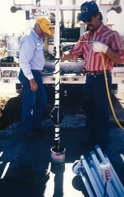 two men standing next to each other with a hose that says ' yamaha ' on it