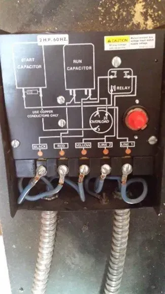 a black box with a red button on top of it