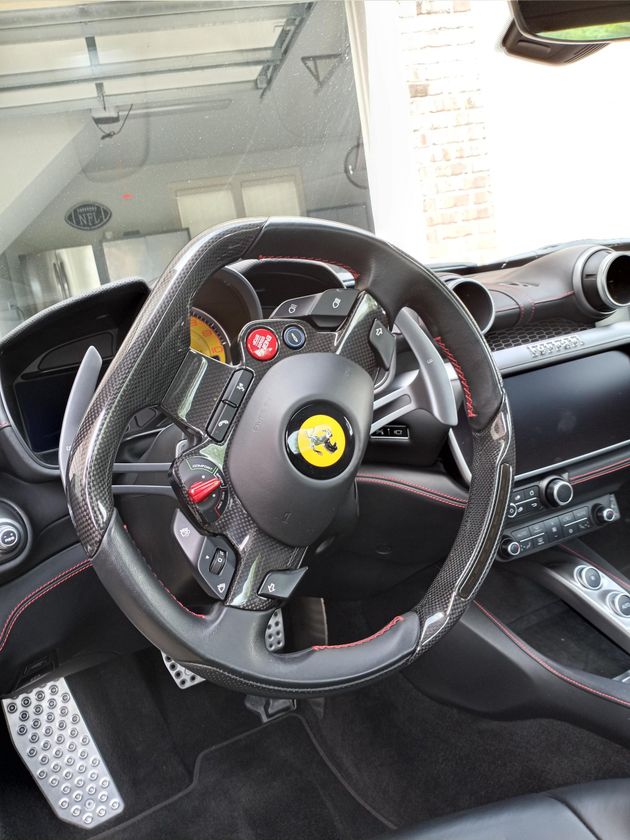 A close up of a steering wheel in a car