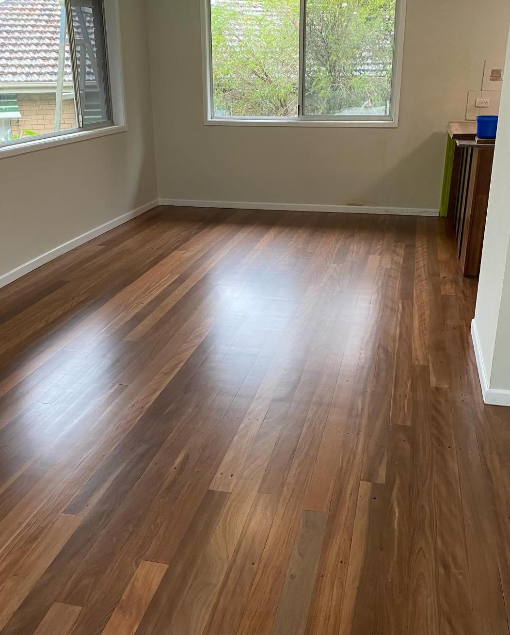 A Living Room With a Wooden Floor and a Window — Timberfection Queensland in Yatala, QLD