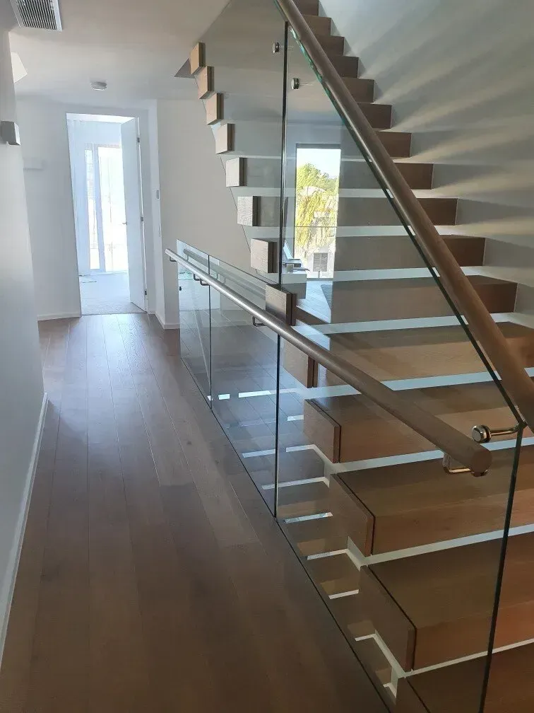 A Staircase With a Glass Railing and Wooden Steps — Timberfection Queensland in Yatala, QLD