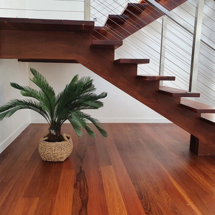 A Wooden Staircase With a Potted Plant on the Floor — Timberfection Queensland in Yatala, QLD