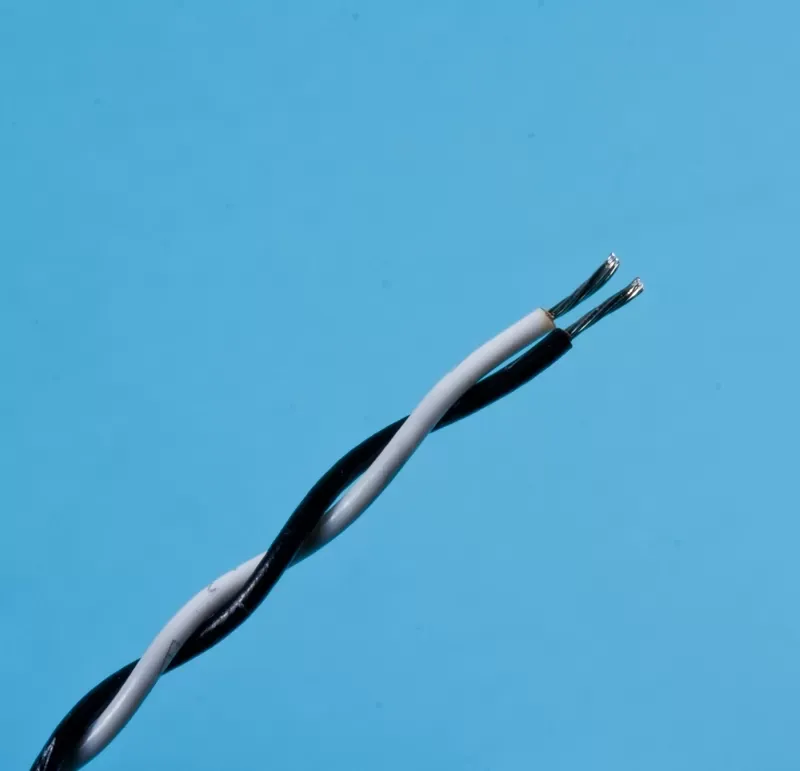 Two twisted electrical wires, one white and one black, with exposed metal tips against a light blue background.