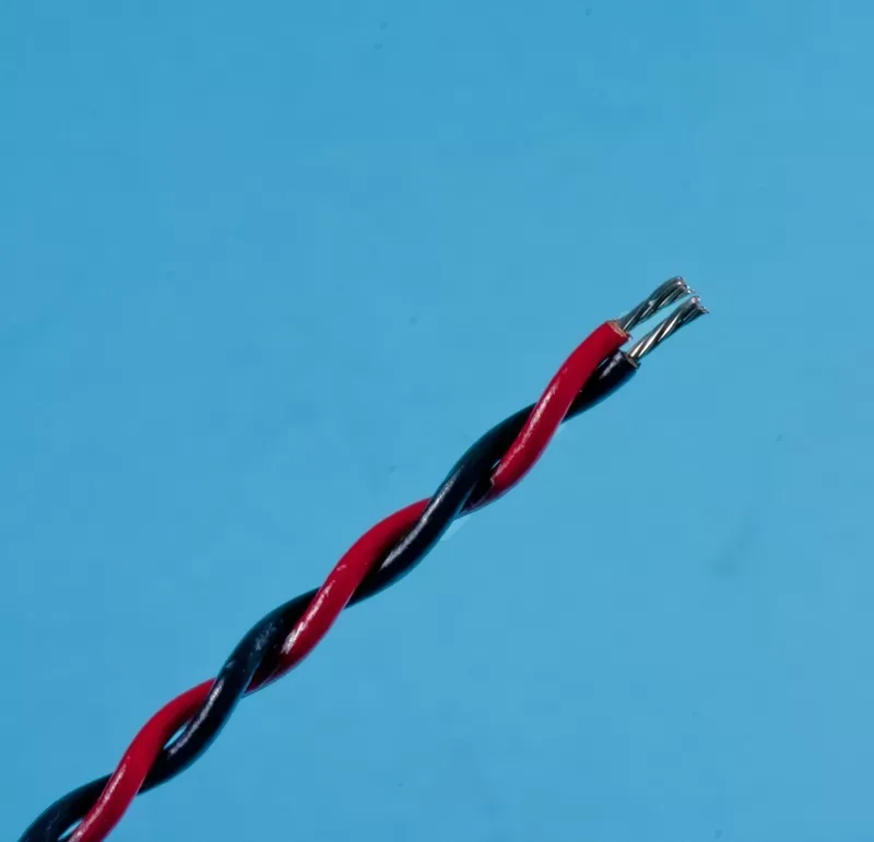 A twisted red and black electrical wire with exposed, stranded metal conductors at the end, set against a blue background.