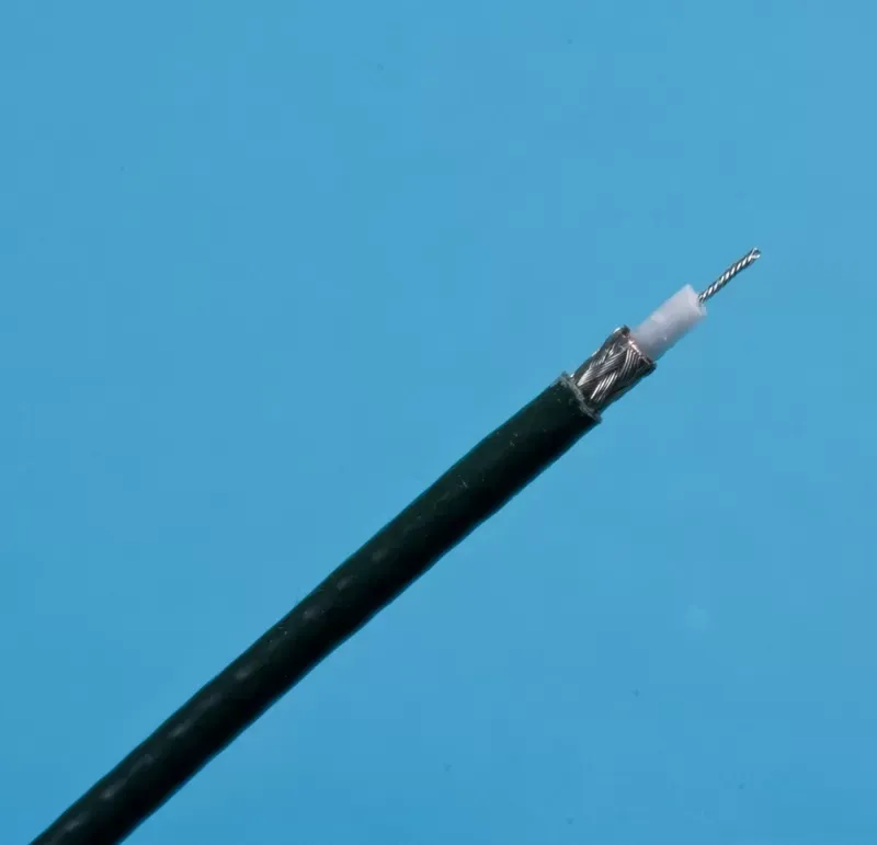 A dark green coaxial cable with a stripped end, revealing the metal mesh shielding, white insulation, and center wire.