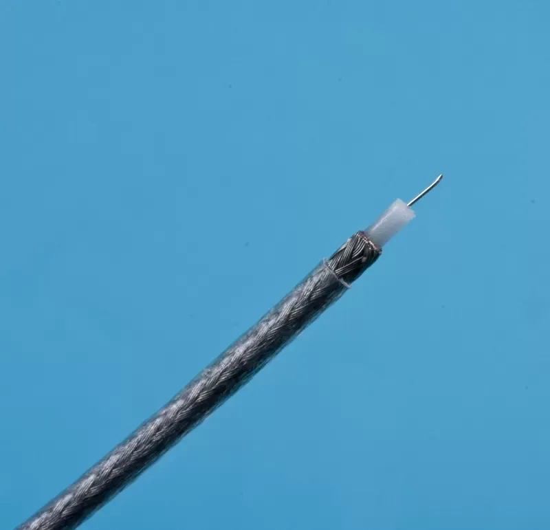 A stripped coaxial cable end showing the exposed center conductor, white dielectric, and braided metal shield.