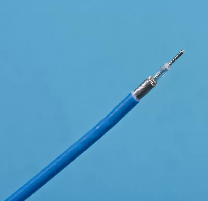 A blue coaxial cable with its outer layers stripped back to reveal the internal insulation and metal conductor wire.