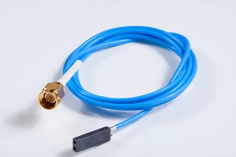A blue cable with a gold SMA connector on one end and a black 2-pin female header connector on the other.