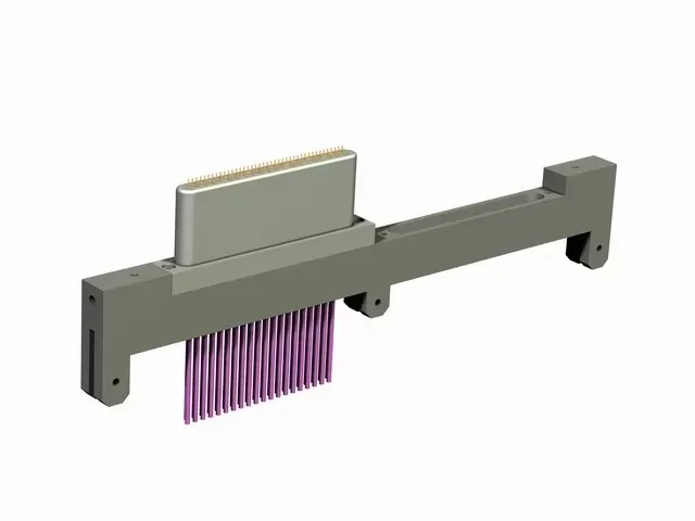 A grey mechanical component with a light-colored rectangular block and a row of thin purple needles extending downward.
