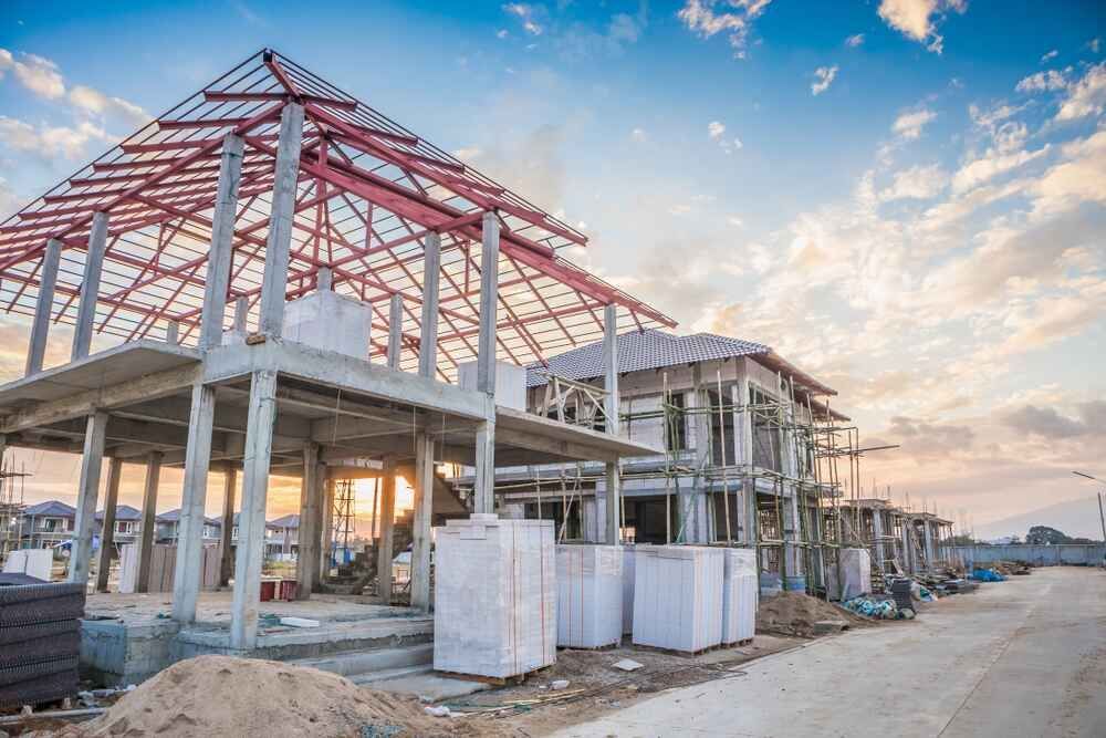 A House Is Being Built On A Construction Site With A Red Roof — Clearspan Builders In Queanbeyan East, NSW