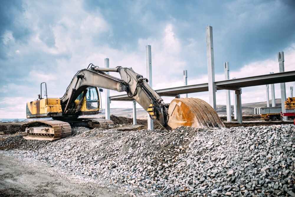A Large Excavator Is Working On A Construction Site — Clearspan Builders In Canberra, ACT

