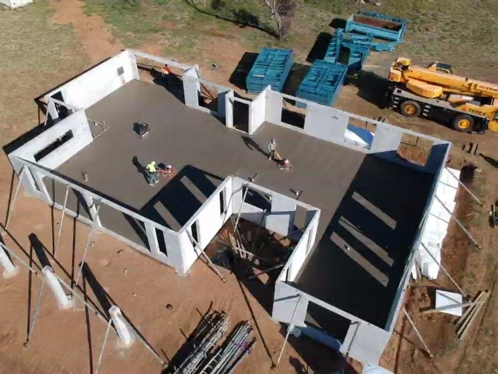 An Aerial View of A Building Under Construction with Men Working Inside — Clearspan Builders In Canberra, ACT
